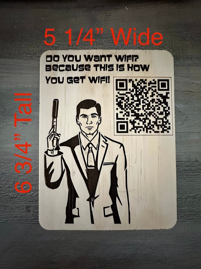A rectangular novelty sign with rounded corners featuring a black-and-white illustration of a man in a suit holding a phone next to a QR code and the text 'DO YOU WANT WIFI BECAUSE THIS IS HOW YOU GET WIFI'. Red text at the top says '5 1/4" Wide' and red text on the left says '6 3/4" Tall' against a dark wood background.