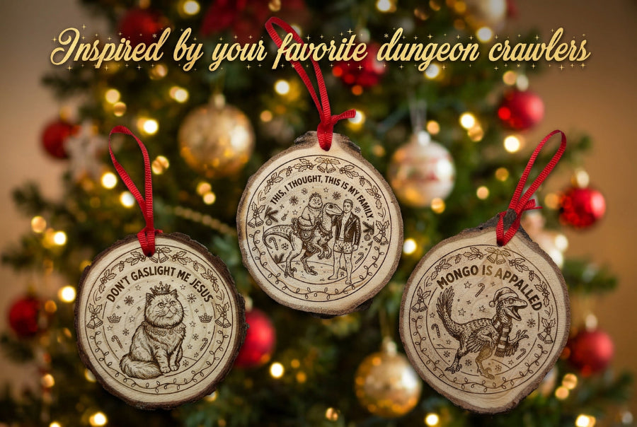 Three round wooden Christmas ornaments with red hanging loops, featuring engraved animal illustrations and text including 'JON GASLIGHT ME JESUS' and 'NONGO IS APPALIED.' They are arranged on a white surface above a green cutting mat.