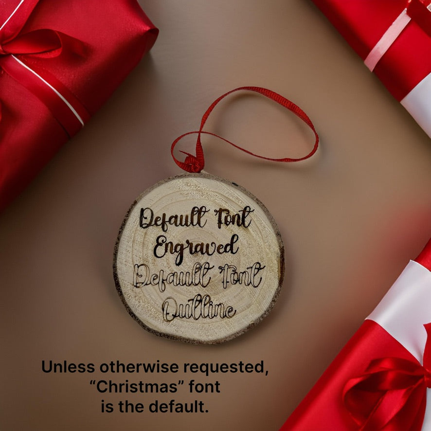 A round wooden Christmas ornament with a natural bark edge and a red hanging ribbon, shown on a warm taupe background with red gift boxes around it. Black engraved text on the ornament reads, 'Default Font Engraved Default Font Outline.