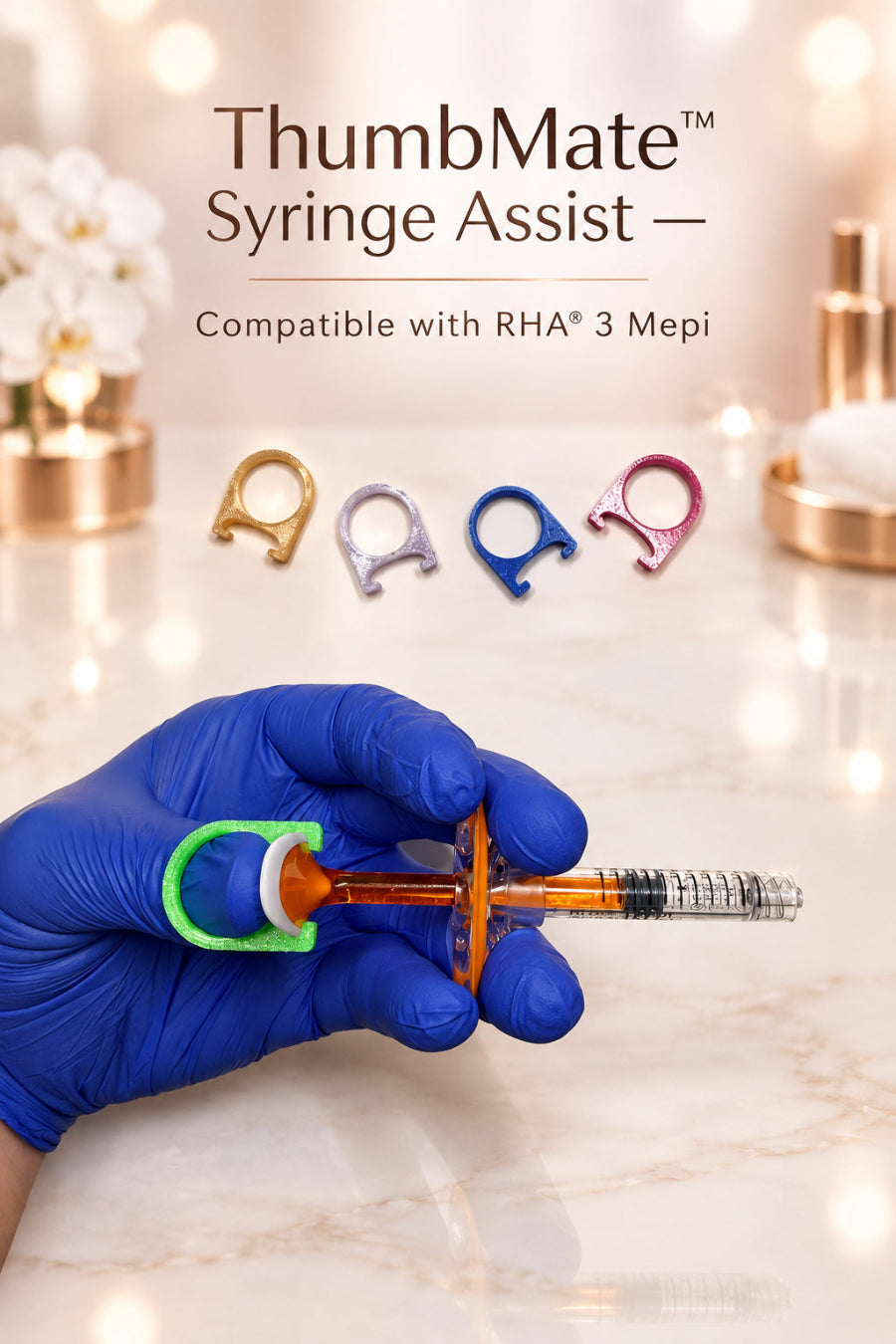 A hand wearing a blue nitrile glove holds a clear syringe filled with orange liquid, fitted with a green and white ring-shaped accessory. Four small ring-shaped accessories in gold, lavender, blue, and pink are lined up on a white sheet of paper above, with a gridded cutting mat visible in the background.