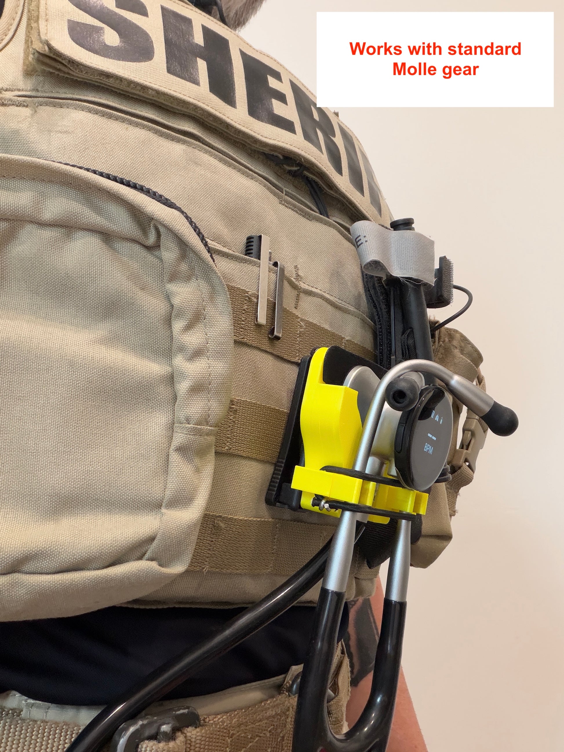 Tactical vest with a yellow and black device attached, labeled 'SHERIFF'.