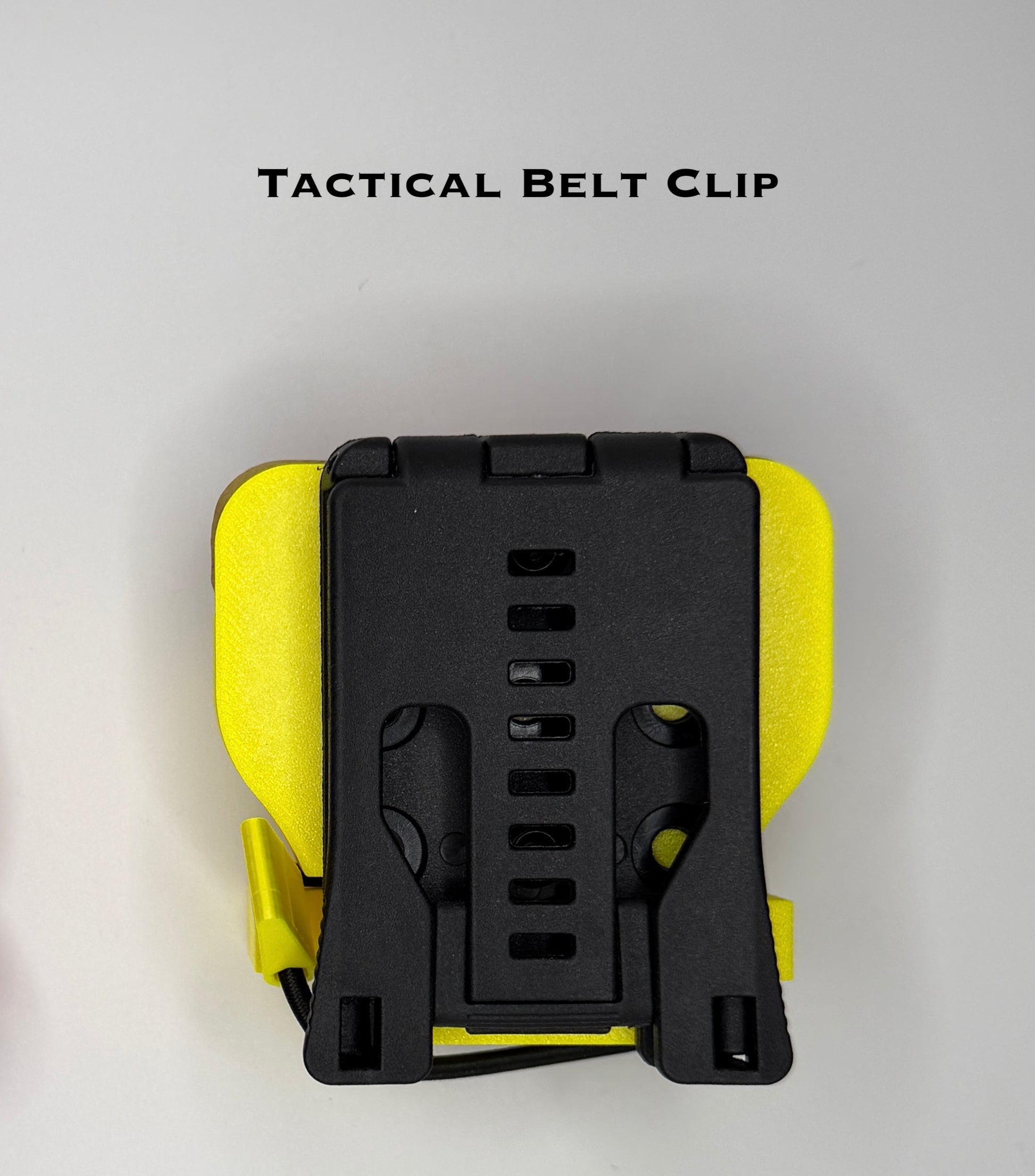 Tactical belt clip with yellow and black design on a gray background