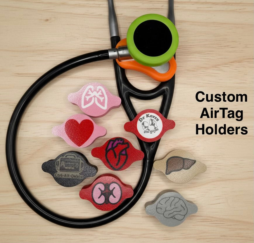 Littmann stethoscope with a green and orange AirTag holder, surrounded by custom holders shaped like lungs, a heart, an anatomical heart, kidneys, a brain and a liver