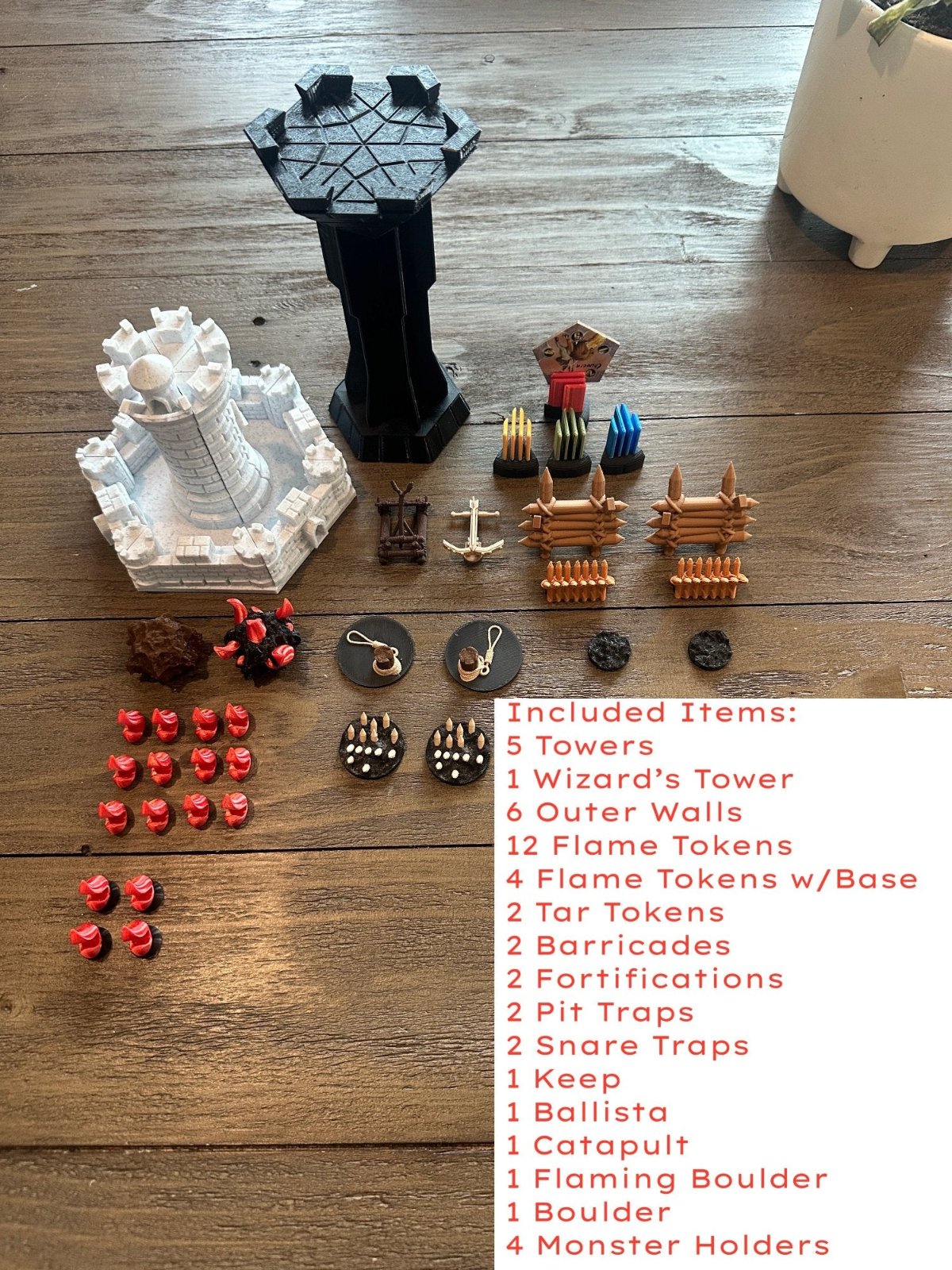 All 3D printed Castle Panic pieces laid out, including the keep, towers, wizard's tower, walls, flames, traps and monster holders, with a list of contents