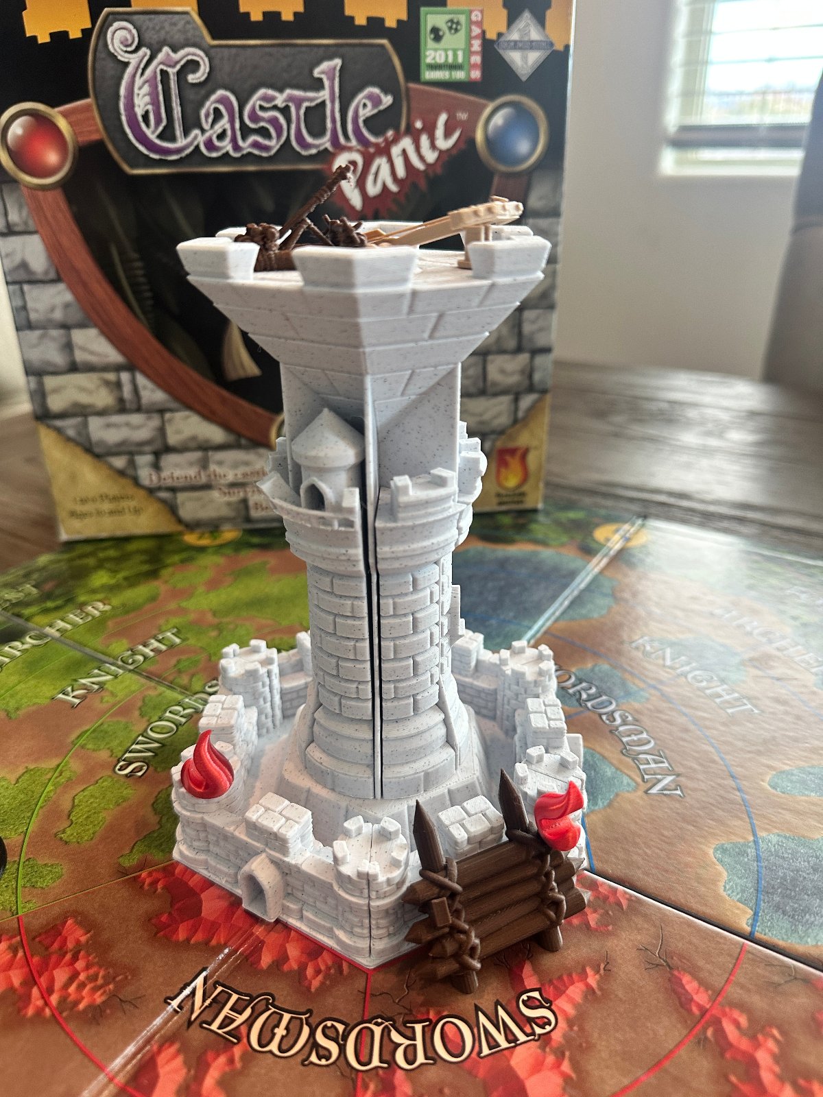 Gray 3D printed Castle Panic keep and towers on the game board