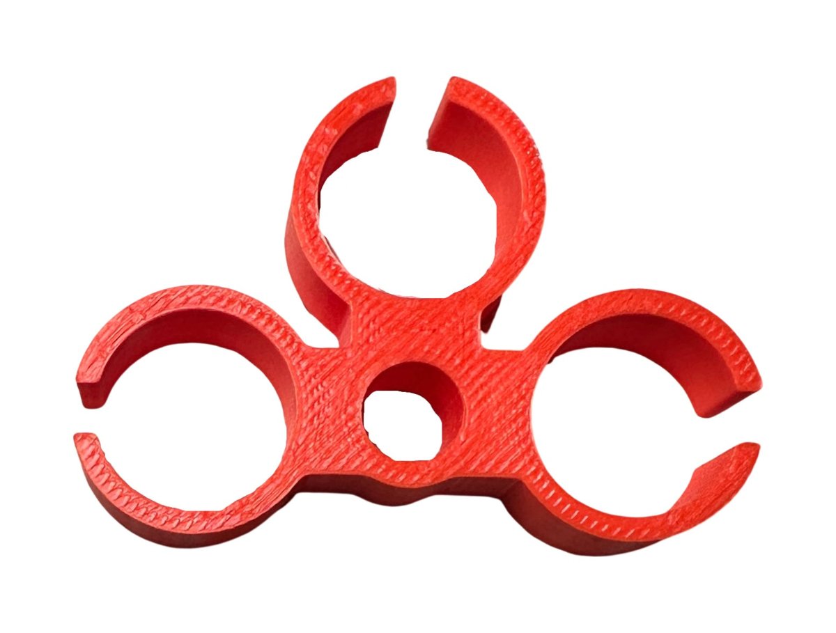 Red three-slot IV drip chamber holder with a center hole for hanging