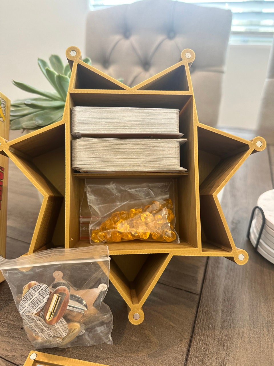 Open star-shaped BANG! card box with compartments holding cards and tokens